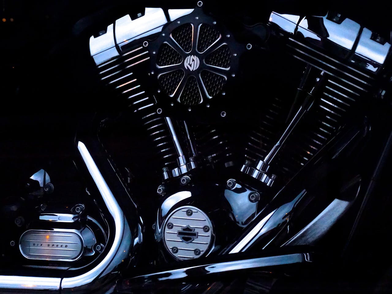 Detailed view of a chrome Harley Davidson motorcycle engine with sleek metal design.